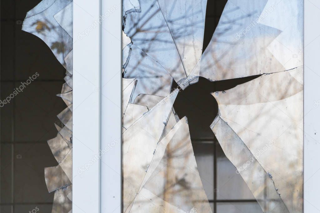 broken window in a residential building, hostilities, housing security