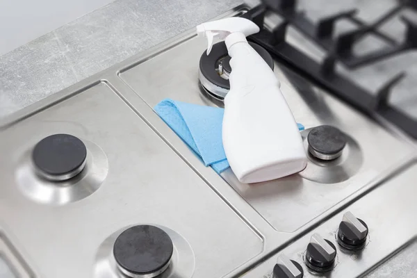 Cleaning a gas stove with kitchen utensils, household concepts, or hygiene and cleaning