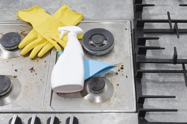 Cleaning a gas stove with kitchen utensils, household concepts, or hygiene and cleaning