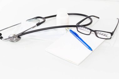 Stetoskop doktor ofisinde. Üstten görünüm Doktor Danışma tablo, boş kağıt kalem ile Pano üzerinde. Kopya alanı