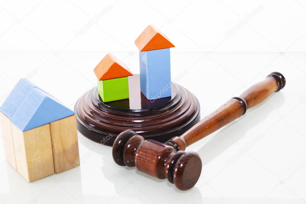 wooden house and judge gavel on a white background. Is isolated.