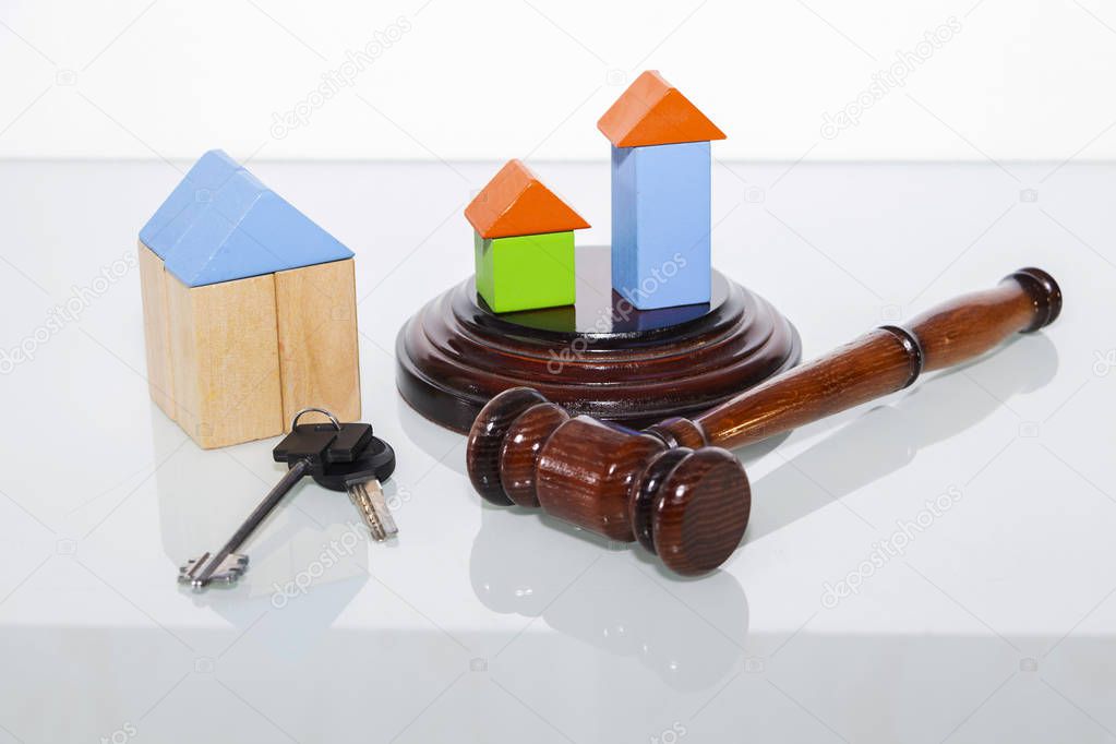 wooden house and judge gavel on a white background. Is isolated