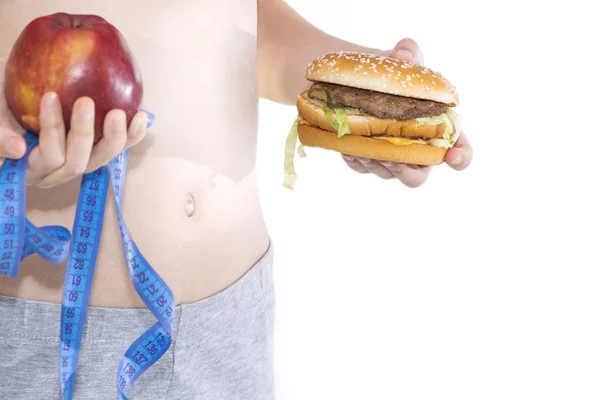 Burger cheeseburger in hands with measure tape isolated on white background. Healthy weight loss diet concept — Stock Photo, Image