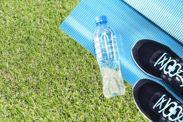 Yoga Mat, sports shoes, water bottle concept of healthy living, healthy eating, sports and diet