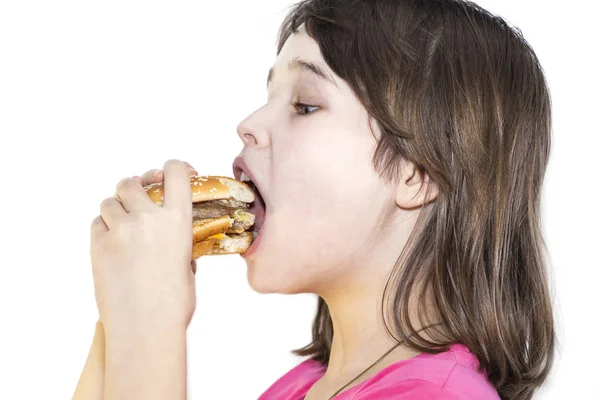 Portrait of a beautiful girl, teenager and schoolgirl, holding a hamburger on a white background. — Stock Photo, Image