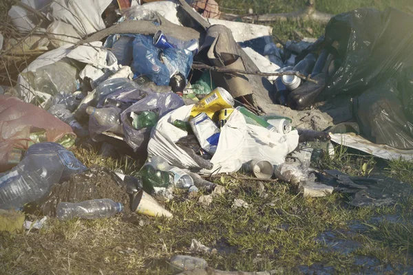 Pile of garage on green grass in the nature environment problems. Nature protection.