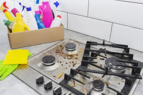 Limpeza de um fogão a gás com utensílios de cozinha, conceitos domésticos, ou higiene e limpeza. — Fotografia de Stock