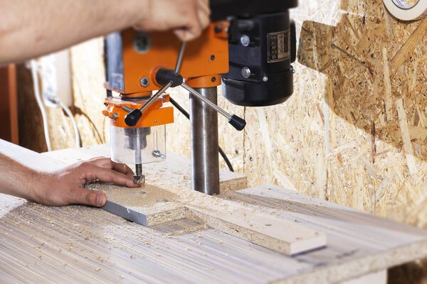 Drill in the drilling machine, making furniture
