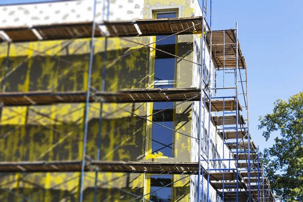 Insulation of walls, installation of scaffolding, high-rise work, energy saving