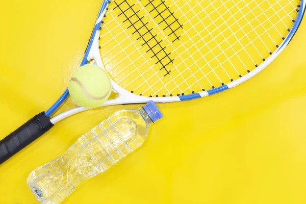 Tenis na jasnym tle. Butelka wody, rakieta, piłka. Fotografie w studio — Zdjęcie stockowe