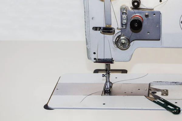 Industrial sewing machine. Clothing manufacturing, tailoring Close up