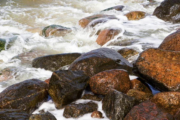 Vagues de mer se brisent sur les rochers, beaucoup de pulvérisation. Journée ensoleillée. — Photo