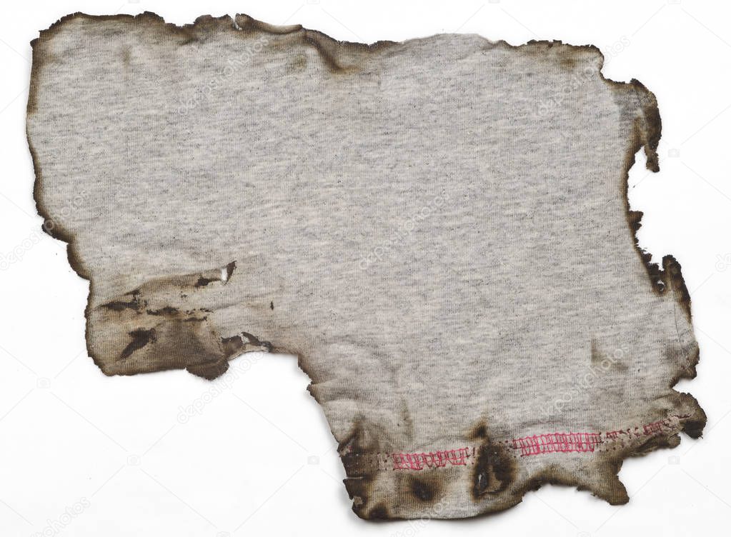 old linen fabric, with burnt edges on white surface. Fabric with bright textur