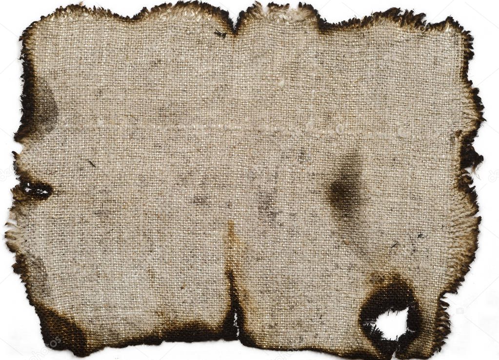 old linen fabric, with burnt edges on white surface. Fabric with bright textur