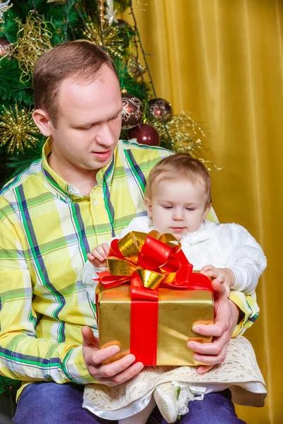 Happy father and child near Christmas fir-tree