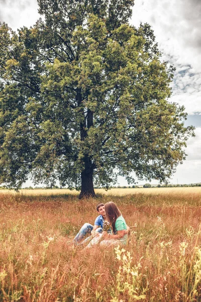 Romantic Couple Relaxing Sitting Field Full Length — Stock Photo, Image