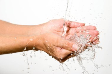 cropped image of water pouring on woman hands isolated on white