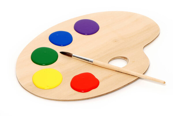 colored paints and paintbrush on palette on white background