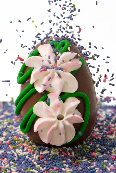 Close Chocolate Tasty Easter Egg Falling Flakes Isolated White — Stock Photo, Image