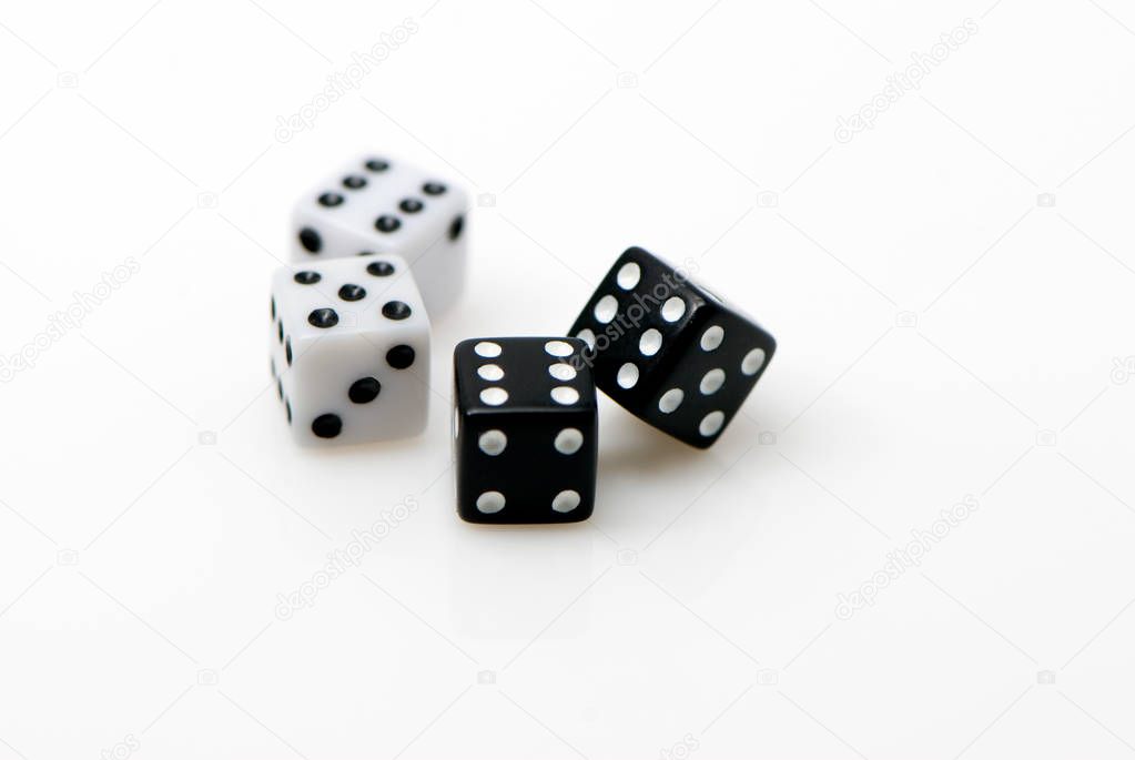 Black and white dices scattered on white background