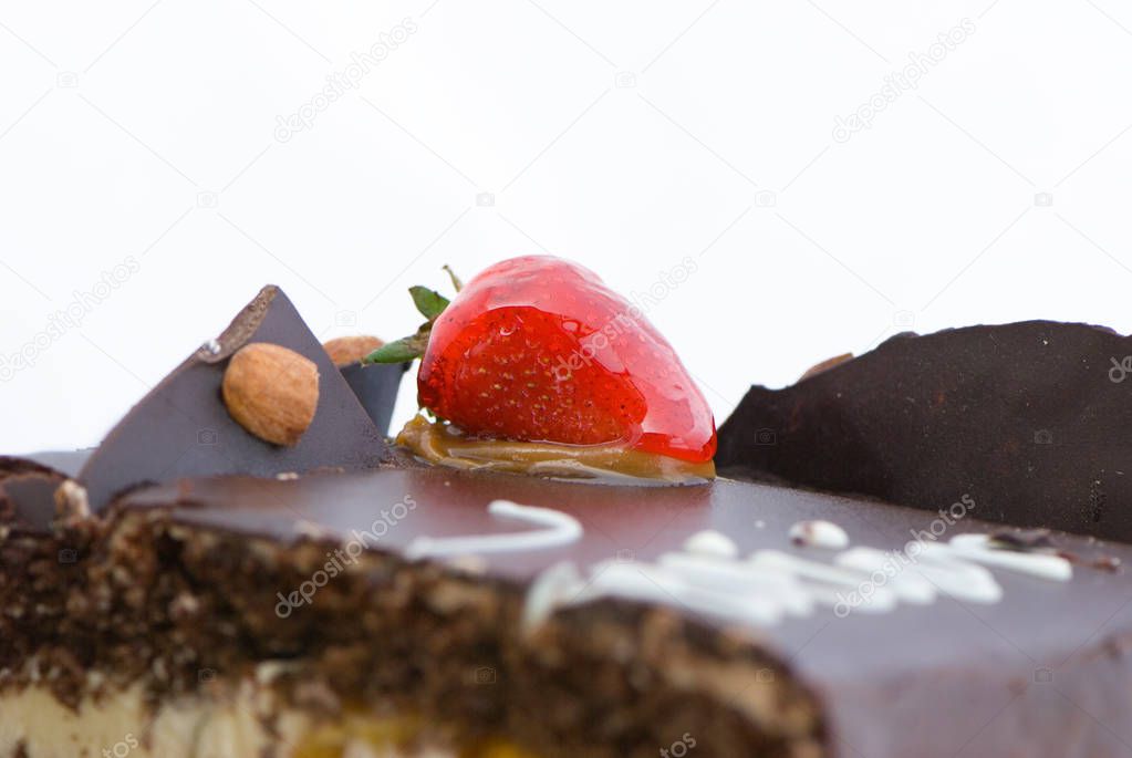 Close up view of chocolate cake with chocolate icing and strawberry