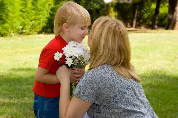 Adorable Son Presenting Bouquet Flowers Mother Park — Stock Photo, Image