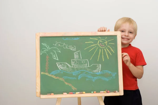 Cute Little Boy Standing Green Chalkboard Hand Drawn Ship Sea — Stock Photo, Image