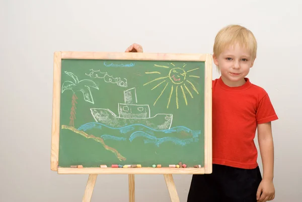 Cute Little Boy Standing Green Chalkboard Hand Drawn Ship Sea — Stock Photo, Image