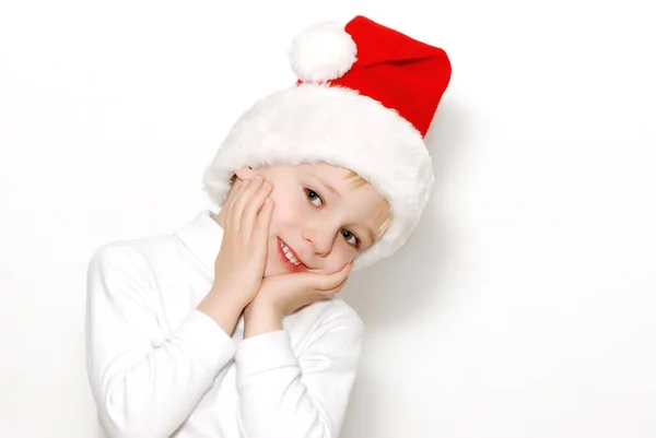 Usměvavý Chlapeček Červený Santa Klobouk Dotkla Jeho Tváře Izolované Bílém — Stock fotografie