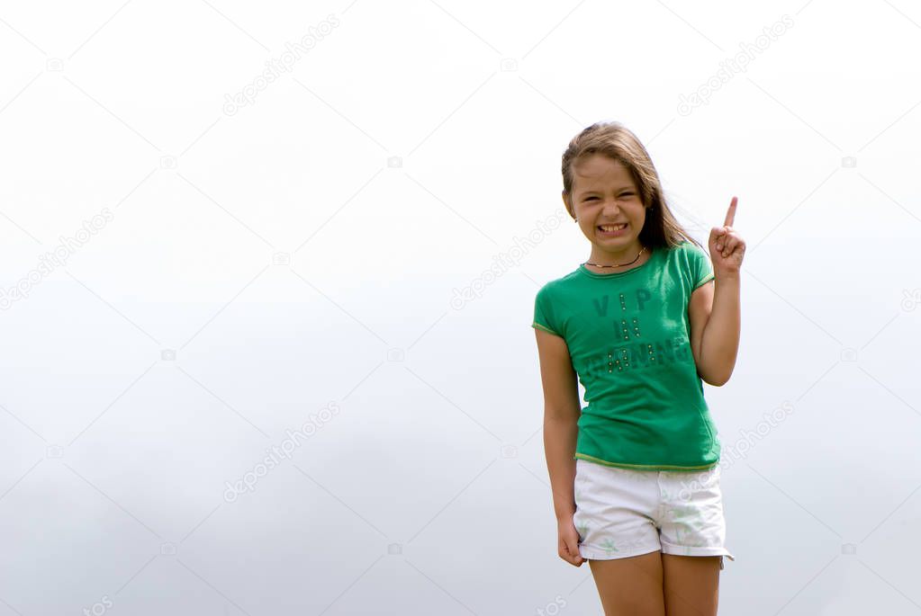 three quarter length portrait of little girl having fun posing on foggy background