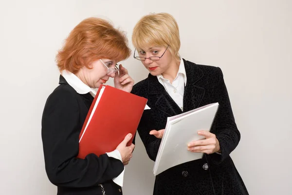 Two Businesswomen Wearing Eyeglasses Holding Folders Documents Standing Light Background — Stock Photo, Image