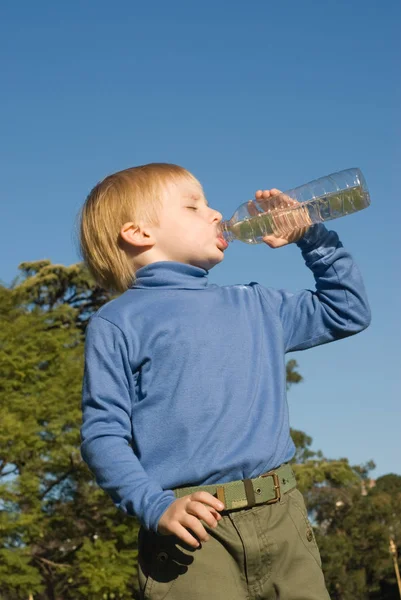 Little Boy Drinking Water Standing Outdoors Blue Sky Background — Stock Photo, Image