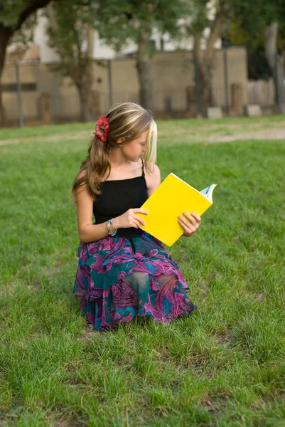 Outdoor Portrait Cute Teen Girl Reading Yellow Book Sitting Green — Stock Photo, Image