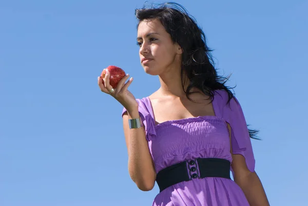 Beautiful Young Woman Eating Apple Front Blue Sky — Φωτογραφία Αρχείου