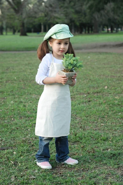 可爱的小女孩的肖像与花盆在公园 — 图库照片