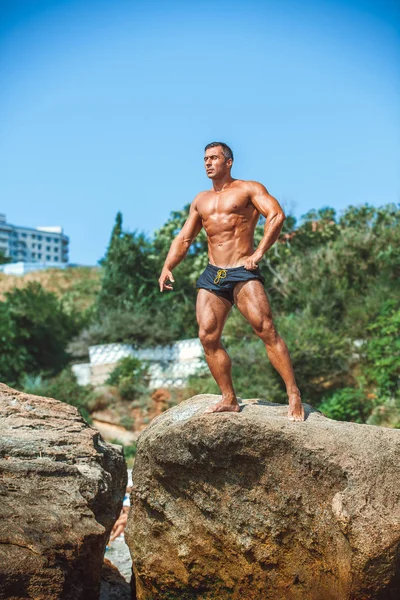 Guapo Atleta Masculino Posando Sobre Rocas — Foto de Stock