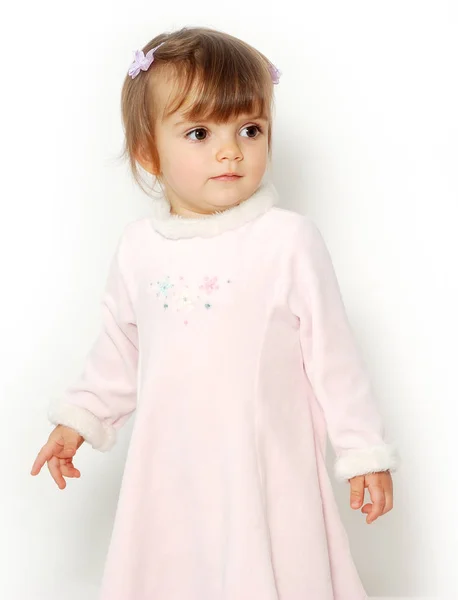 可爱的女孩在白色背景的粉红色礼服的肖像 — 图库照片