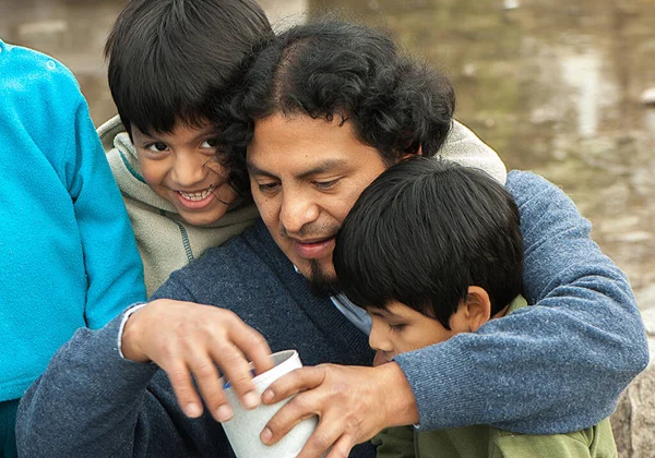 Portrait Latin Family Sitting Street Drinking Mate Stock Image