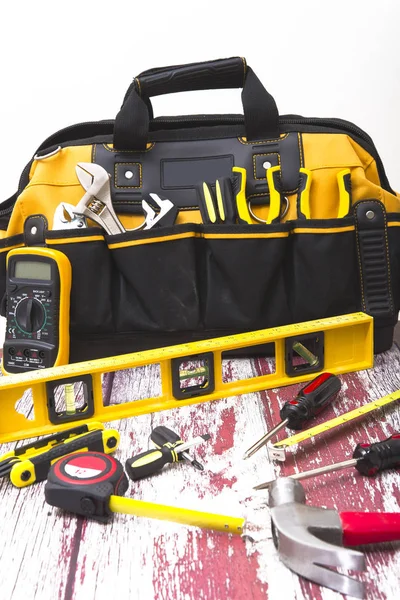 bag with various tools on a vintage floor close-up