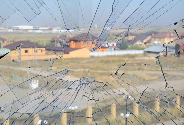 broken window glass on the background of houses