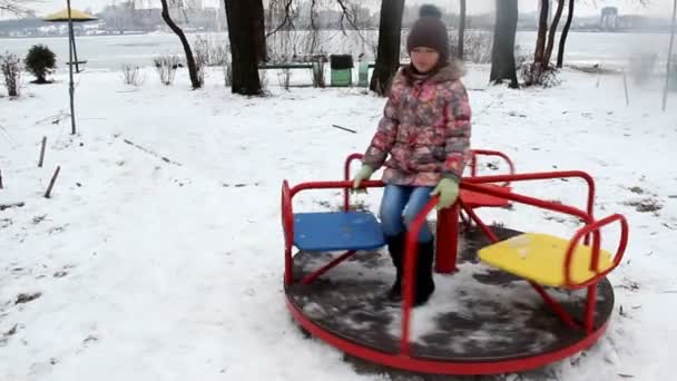 Little Girl Riding Carousel Playground Winter — Stock Video