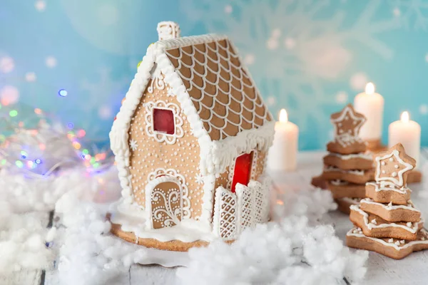 Gingerbread house and gingerbread trees on a festive Christmas background