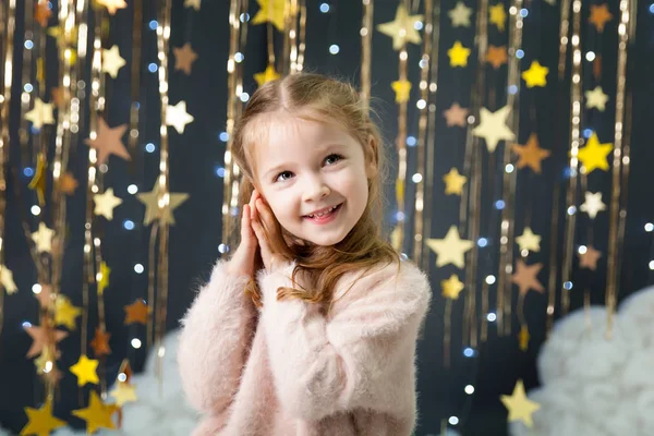 Girl in a studio with a gold stars decor — Stock Photo, Image