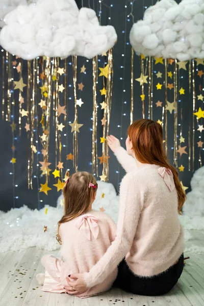 Menina bonito com uma mãe segurando um presente — Fotografia de Stock