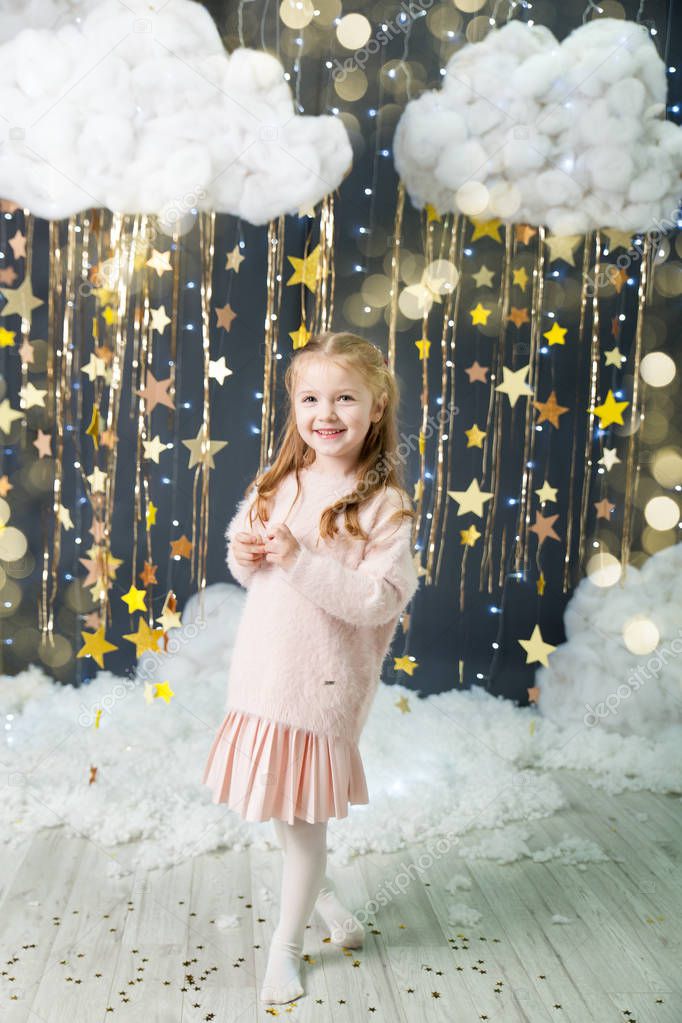Girl in a studio with a gold stars decor