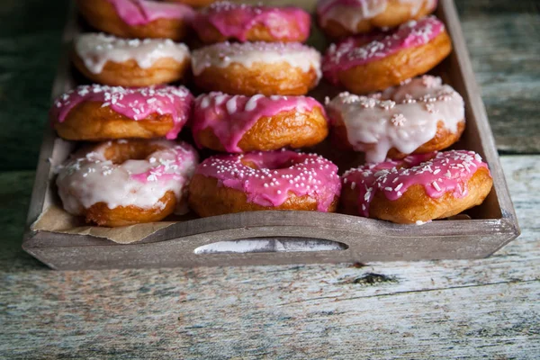 Sweet and colourful donuts with sprinkles and frosting — 图库照片