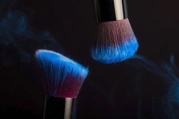 Cosmetics brush and colorful makeup powder