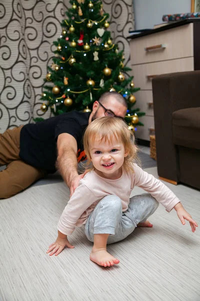 Funny little girl playing with her father — Stock Photo, Image