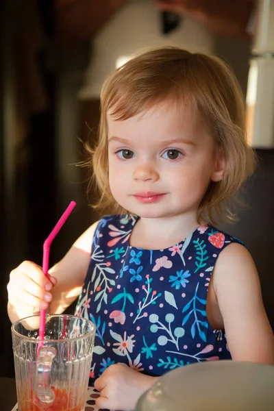 Bebé niña bebiendo jugo de tomate —  Fotos de Stock