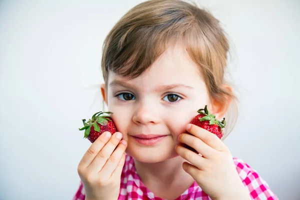 Adorable Smiling Little Girl Holding Two Big Strawberries Her Cheeks — Stock Photo, Image